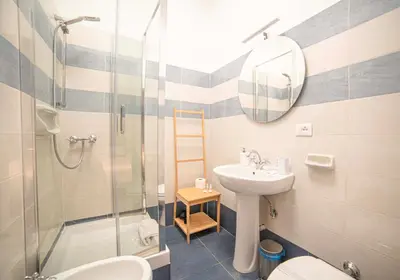 a bathroom with a sink toilet and a shower at Fontana di Trevi sweet apartment in Rome