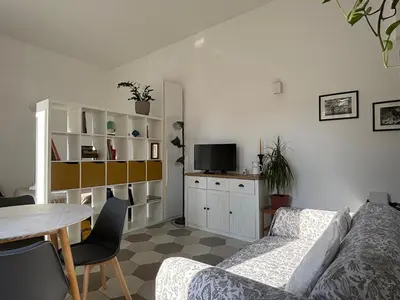 a living room with a couch and a table at Renovated studio near the Vatican in Rome