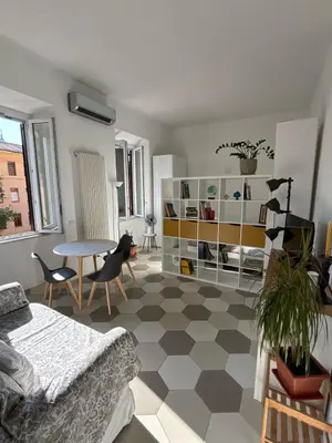 a living room with a couch and a table at Renovated studio near the Vatican in Rome