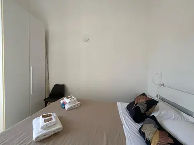 a bedroom with a bed with two towels on it at Renovated studio near the Vatican in Rome