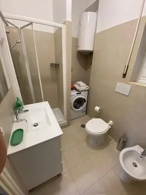 a small bathroom with a toilet and a sink at Houses Donatello & Tiziano Roma in Rome