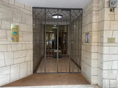 a lobby of a building with a revolving door at Houses Donatello & Tiziano Roma in Rome