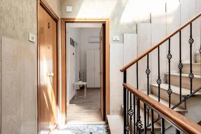 a hallway with stairs leading to a room at central comfortable studio apartment in Rome