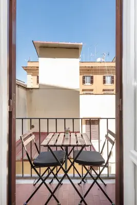 a table and two chairs on a balcony at central comfortable studio apartment in Rome