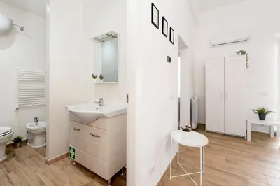 a white bathroom with a sink and a toilet at central comfortable studio apartment in Rome