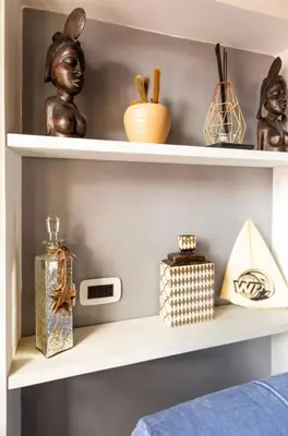 a shelf with various items on it at Colosseo Luxury Suite in Rome