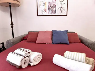 a bed with towels on it in a room at Porta Labicana House -10 minutes from Termini Station in Rome