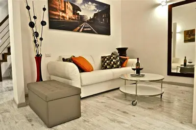 a living room with a white couch and a table at Opera House in Rome