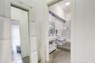 a bathroom with a sink and a toilet and a mirror at New Suite Barberini Area in Rome