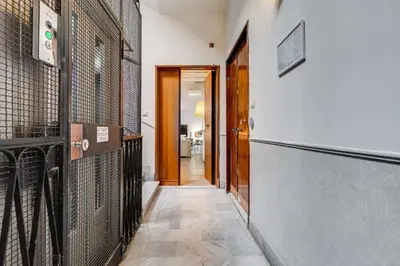 a hallway with some cages on the wall at New Suite Barberini Area in Rome