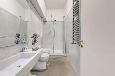 a white bathroom with a toilet and a shower at New Suite Barberini Area in Rome