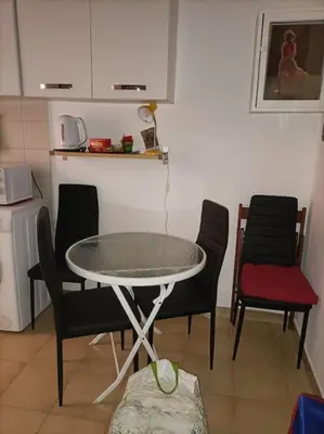 a table and chairs in a room with a kitchen at Appartamento di Mila in Rome