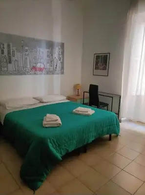 a green bed with two towels on top of it at Appartamento di Mila in Rome