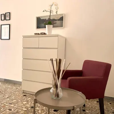 a living room with a chair and a table at Lazy Time Apartment in Rome