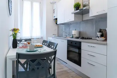 a kitchen with a small table and a stove at Colosseo Home San Giovanni in Rome