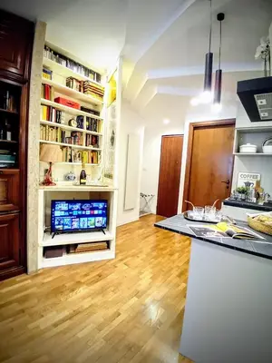 a kitchen with a counter and a wooden floor at ad vatican luxury apartment in Rome