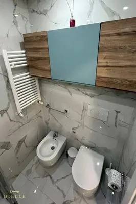 a bathroom with a white toilet and a sink at Dielle Suite ROMA in Rome