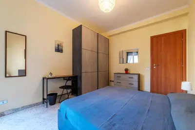 a bedroom with a large bed and a dresser at San Paolo Apartment - Charme Holidays in Rome