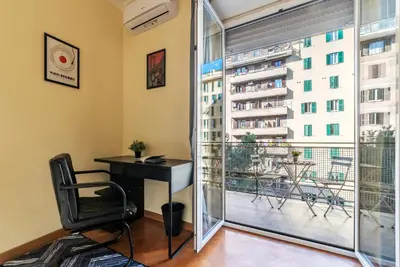 a room with a desk and a large window at San Paolo Apartment - Charme Holidays in Rome