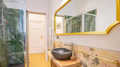 a bathroom with a bowl sink on a wooden table at Candia Delizioso Appartamento vicino al Vaticano in Rome