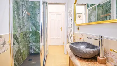 a bathroom with a stone sink on a counter at Candia Delizioso Appartamento vicino al Vaticano in Rome