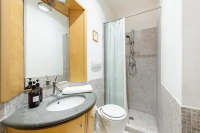 a bathroom with a sink and a toilet and a shower at Beige luxury apartment Rome in Rome