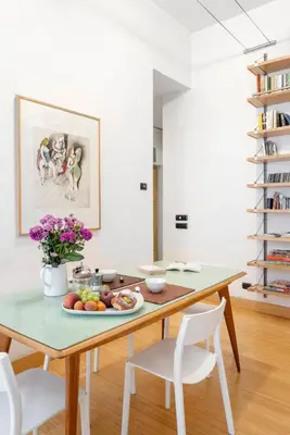 a dining room table with a plate of fruit on it at Beige luxury apartment Rome in Rome