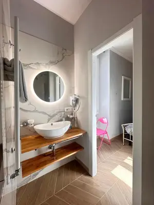 a bathroom with two toilets and a sink and a tv at Angelus Vaticanus Room in Rome