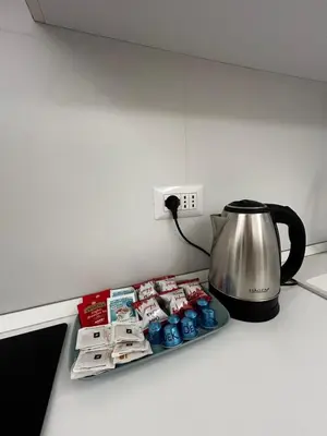 a kitchen counter with a coffee pot on a stove at flaTminio modern & nice apartment in Rome