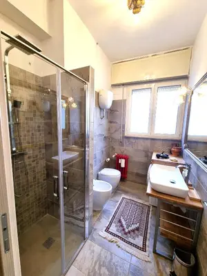 a bathroom with a shower and a sink and a toilet at Happy Home Piramide Cestia Lussuoso Unico Esclusivo a Roma in Rome