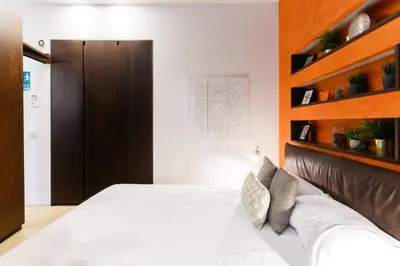 a bedroom with a bed with a wooden headboard at Trastevere Charme in Rome