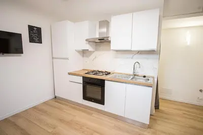 a kitchen with white cabinets and a sink at ODESCALCHI LOFT in Rome