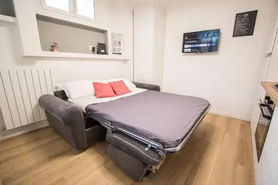 a bed with two red pillows on it in a room at ODESCALCHI LOFT in Rome