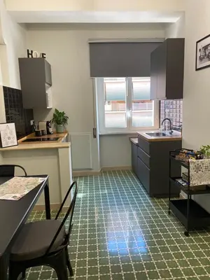 a kitchen with a sink and a table and chairs at Bright apartment near San Pietro in Rome