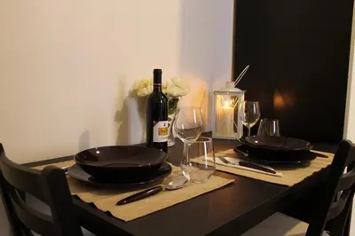 a table with a bottle of wine and glasses at Vatican Santamaura 39 in Rome