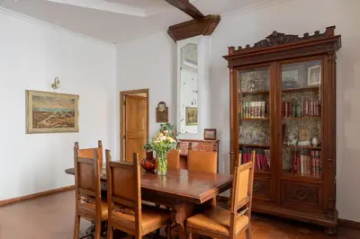 a dining room with a wooden table and chairs at iFlat Elegant 3 bedroom apt near the Pantheon in Rome