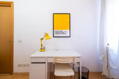 a white desk with a lamp and a chair at Leoncavallo Retreat in Rome