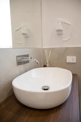 a white sink in a bathroom with a mirror at Ghirlanda House in Rome
