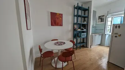 a table and chairs in a room with a kitchen at Euforia House in Rome