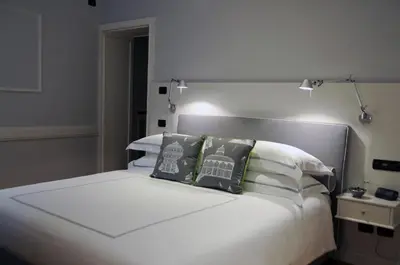 a bedroom with a white bed with pillows at Suite Fontana di Trevi in Rome