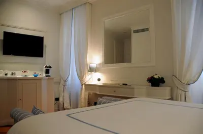 a hotel room with a bed and a mirror at Suite Fontana di Trevi in Rome