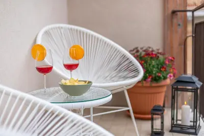 two glasses of wine and a bowl of fruit on a table at Cornelia Elegance House in Rome