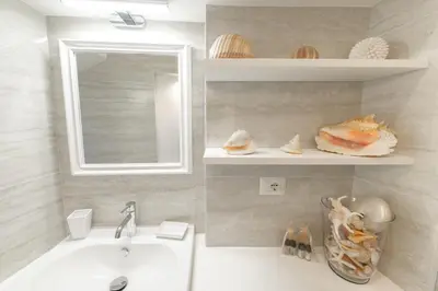 a bathroom with a sink and a mirror at Pantheon Boutique Apartment in Rome