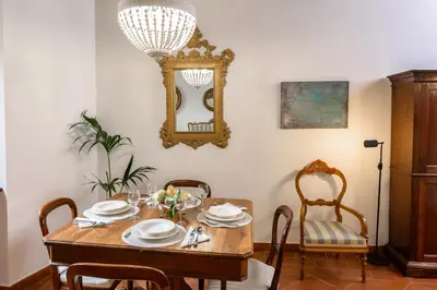 a dining room with a table with chairs and a mirror at Pantheon Boutique Apartment in Rome