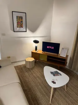 a living room with a couch and a tv at Pietra Apartment 2 , Colosseo in Rome