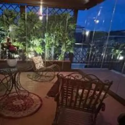 a living room with two chairs and a table at Lovely Terrace Aurelia in Rome