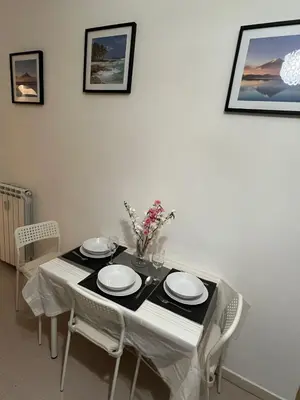 a dining room table with plates and flowers on it at centro stazione tuscolana in Rome