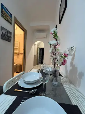 a table with plates and flowers on top of it at centro stazione tuscolana in Rome