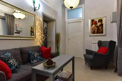 a living room with a couch and a chair at Best Rooms Termini in Rome