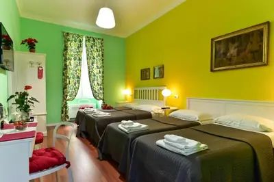 a room with three beds with green walls at Best Rooms Termini in Rome